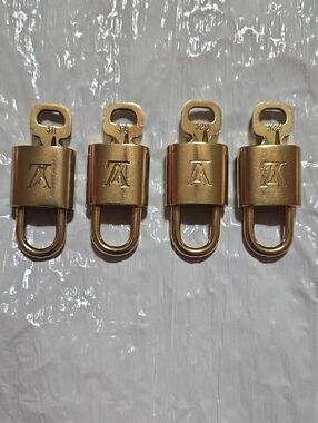 Louis Vuitton Gold Padlock Set of Four with LV Monogram